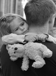 Father provoding support for daughter learning to play guitar